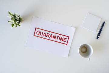 Abandoned workplace of a sick employee in the office due to coronavirus and quarantine with a cup of finished coffee. Worldwide pandemic concept