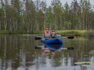 Father and son in kayak. Active extreme holidays in Karelia. Water tourism. Ecotourism, visiting fragile, pristine, undisturbed natural areas