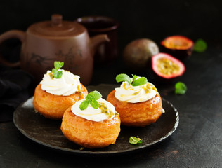 Rum woman (brioche) with cream and passion fruit. Dessert. Selective focus