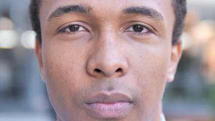 Obraz premium Serious African Man Sitting Outdoor