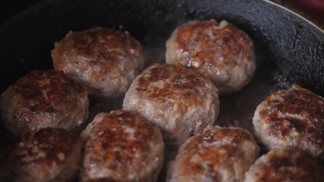 Home cooking. Roasting the meatballs in sunflower oil in a cast iron skillet.