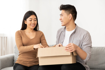 Happy asian family unpacking up their stuff