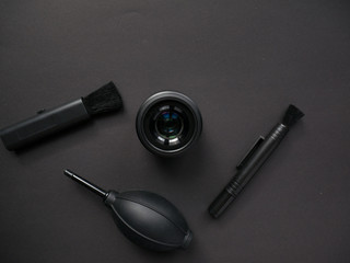 Camera cleaning kits and camera gears on colored background