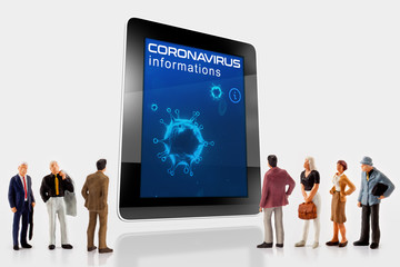 miniature peoples in front a digital tablet with an information about the corona virus