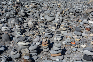 Stones pyramid on pebble beach symbolizing stability, zen, harmony, balance.