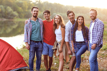 Group of people smiling standing on a picnic - Powered by Adobe