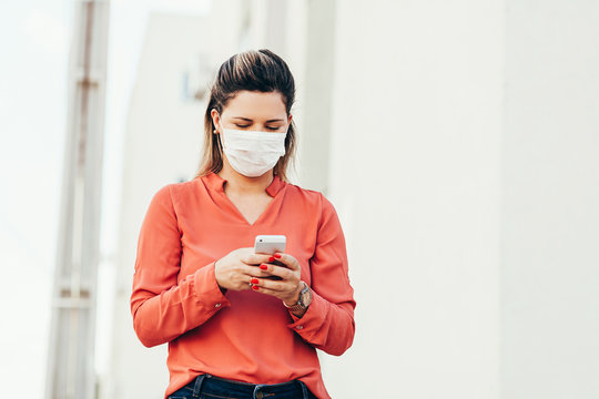 Brazilian woman wearing face mask because coronavirus pandemic in the city. Covid-19