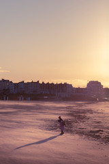 couple walking on the beach in Margate at sunset