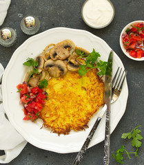 Potato pancake with salad and mushrooms. Selective focus
