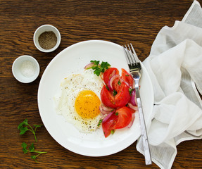Fried egg with tomato salad. Healthy breakfast. Selective focus