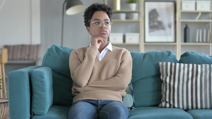 Obraz premium The African Girl Thinking while Sitting on Couch