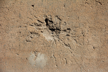 Holes on the wall from shells, bullets.