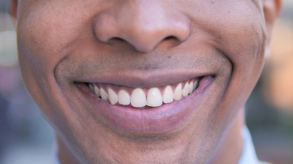 Close up of Smiling Young African Man Lips