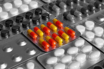 medicine pills and capsules in packs. background