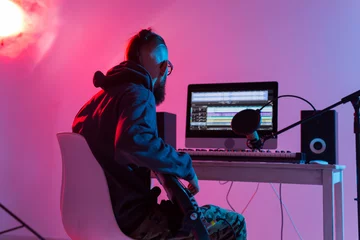 Schilderijen op glas Musician and making music concept - Male sound producer working in recording studio. © satura_