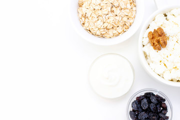 Breakfast concept. cottage cheese with walnuts, oatmeal, raisins and sour cream on a light background. white