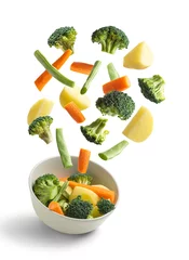Foto op Plexiglas Boiled vegetables flying on white background. Creative concept © Miquel