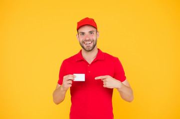 Happy to serve. Discount card. Business contact. Delivered to your destination. Service delivery. Courier and delivery. Postman delivery worker. Man red cap yellow background. Delivering purchase
