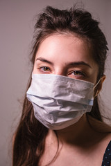 The girl wears a mask protects against the flu or coronavirus. Doctor in mask. Self-isolation