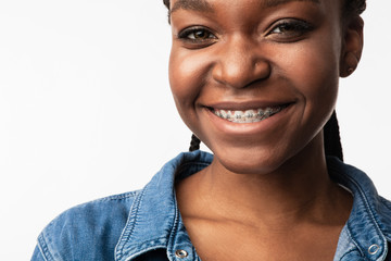 African Girl With Braces Smiling To Camera Posing In Studio