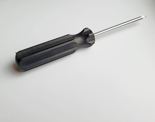 cross head screwdriver with black plastic handle in classic shape, isolated on white background
