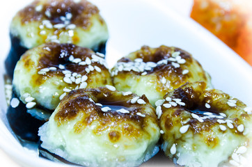 Set of baked rice rolls, seafood and cream cheese close-up. Delicious and healthy food.