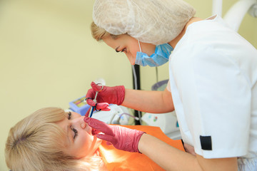 The dentist performs manipulations with the patient.