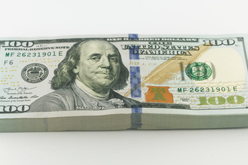 Stack of american money, one hundred dollar cash banknotes on white background, lot of one hundred dollar bills