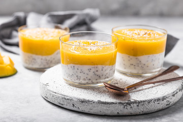 Chia seed pudding with mango in glass jars. Clean eating, healthy vegan vegetarian food concept