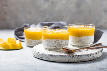 Chia seed pudding with mango in glass jars. Clean eating, healthy vegan vegetarian food concept