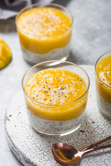 Chia seed pudding with mango in glass jars. Clean eating, healthy vegan vegetarian food concept