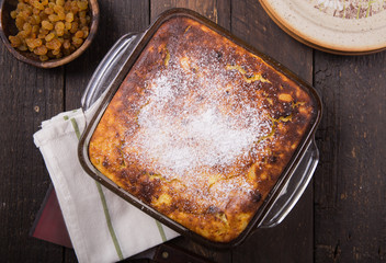 Cottage cheese casserole with raisins on top. Flat lay, top view.