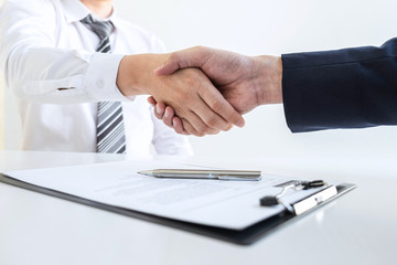 Good deal of interview, Business people and recruiter shaking hands greeting or get acquainted of conducting a job interview while sitting at the working meeting in office