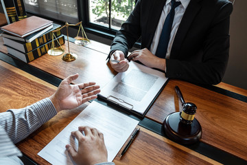 Professional male lawyer or counselor discussing negotiation legal case with client meeting with...