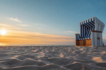 White sand beach and wicker chair on Sylt island - obrazy, fototapety, plakaty