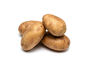 raw dirty potatoes on a white background