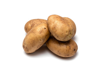 raw dirty potatoes on a white background