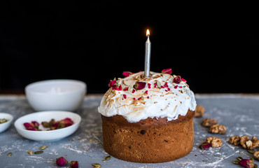 The Easter cake is beautifully decorated and with a candle.