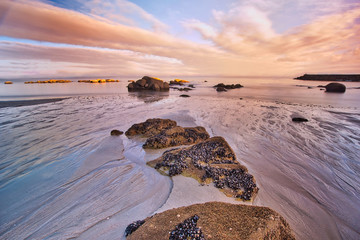 galicia beach with rocks at sunset