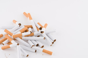 a pile of broken cigarettes on a white background