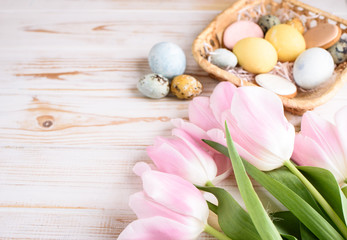 Obraz na płótnie Canvas Beautiful Easter composition of eggs with natural colors, gingerbread, flowers, feathers. Flat lay