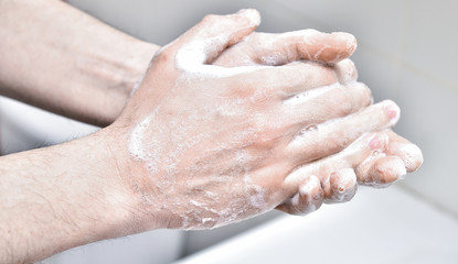 Man washes his hands with soap. Individual hygiene and protection