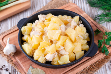 Stewed potatoes with meat in a pan