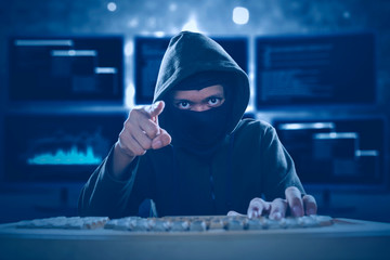 Hacker with mask showing a threatening gesture