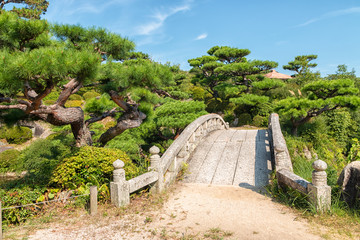 Stone Bridge and Pines  at the Old Mori Garden in Yamaguchi, Japan