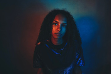 Artistic portrait with color lights of a young woman