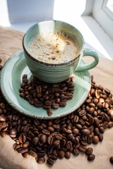 cup of cappuccino and beans