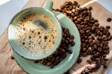 cup of coffee and beans on wooden background
