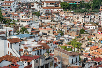 Fototapeta na wymiar Scenic view of Taxco, Mexico. Overview of dense buildings on steep hills of colonial town of Taxco