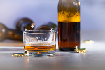 Close-up of a glass of beer and beer bottles